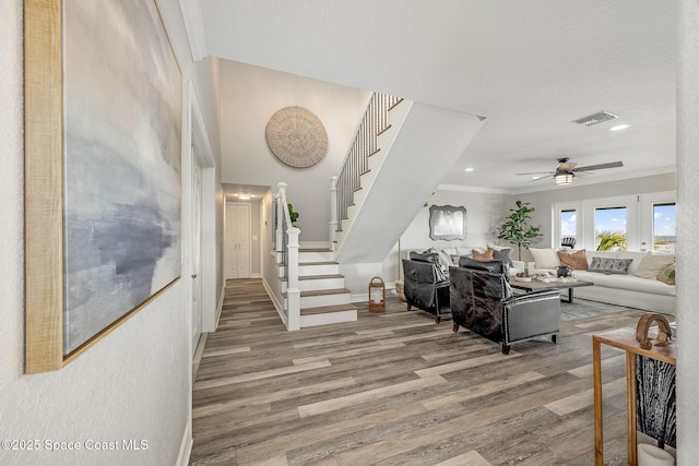 living room featuring ceiling fan, crown molding, and hardwood / wood-style floors