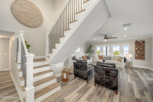 living room featuring ceiling fan, french doors, ornamental molding, and hardwood / wood-style floors