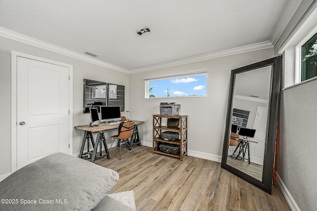 office with light wood-type flooring and crown molding