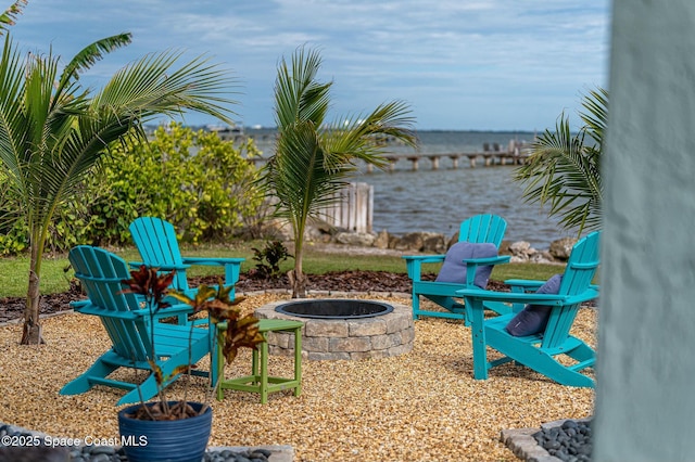 view of patio with a water view and an outdoor fire pit