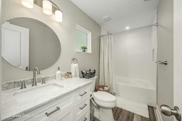 full bathroom featuring toilet, vanity, shower / bath combo with shower curtain, and hardwood / wood-style flooring