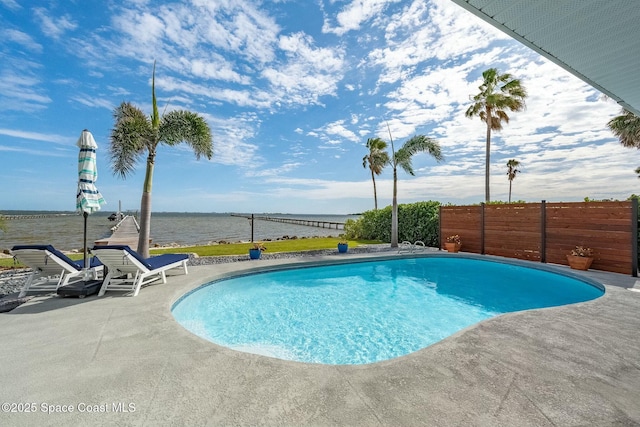 view of swimming pool with a water view and a patio