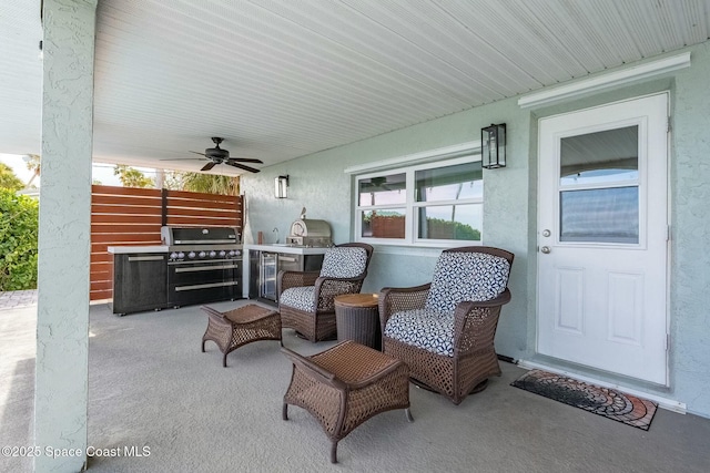 view of patio with ceiling fan and an outdoor kitchen