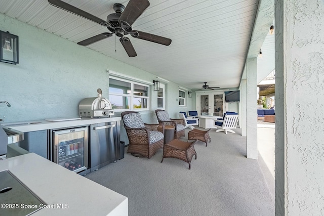 view of patio with wine cooler, exterior kitchen, a grill, and outdoor lounge area