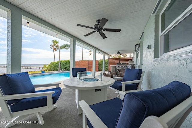 view of patio / terrace featuring ceiling fan and a fenced in pool