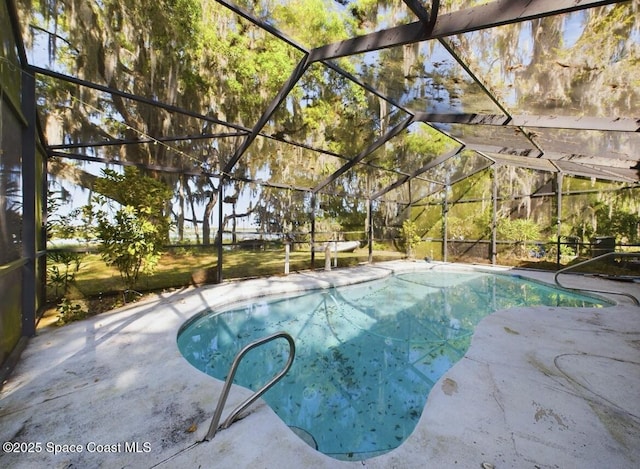 view of swimming pool featuring a lanai and a patio