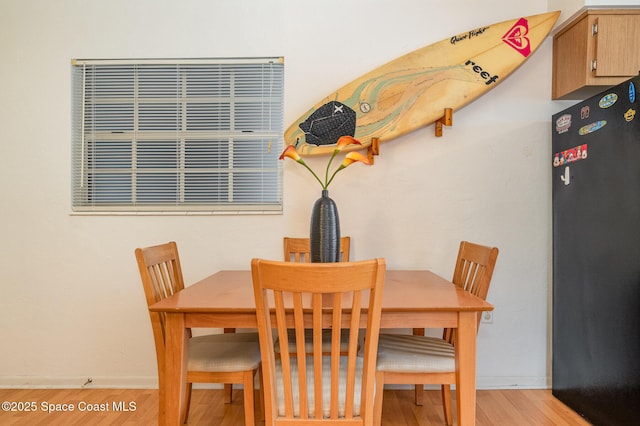 405 Adams Ave Unit 10, Cape Canaveral, FL 32920 - dining area with light wood-style flooring and baseboards