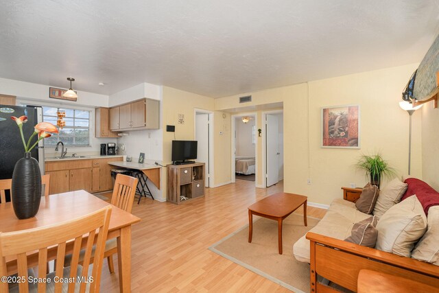 405 Adams Ave Unit 10, Cape Canaveral, FL 32920 - living area featuring light wood-type flooring and baseboards