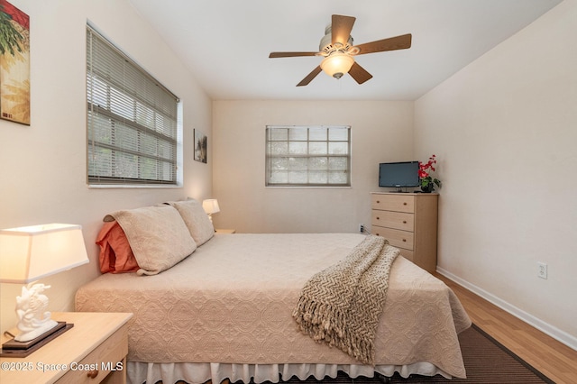 405 Adams Ave Unit 10, Cape Canaveral, FL 32920 - bedroom featuring wood finished floors, multiple windows, and a ceiling fan
