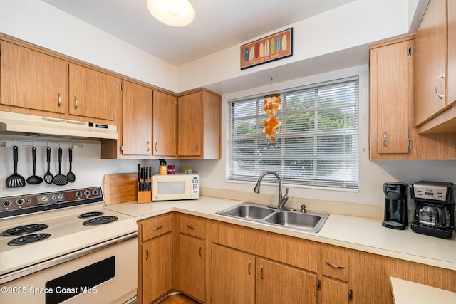 405 Adams Ave Unit 10, Cape Canaveral, FL 32920 - kitchen with white appliances, under cabinet range hood, and light countertops