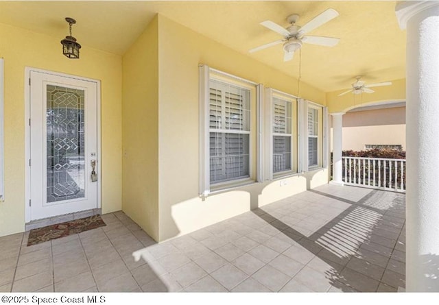 doorway to property with ceiling fan and covered porch