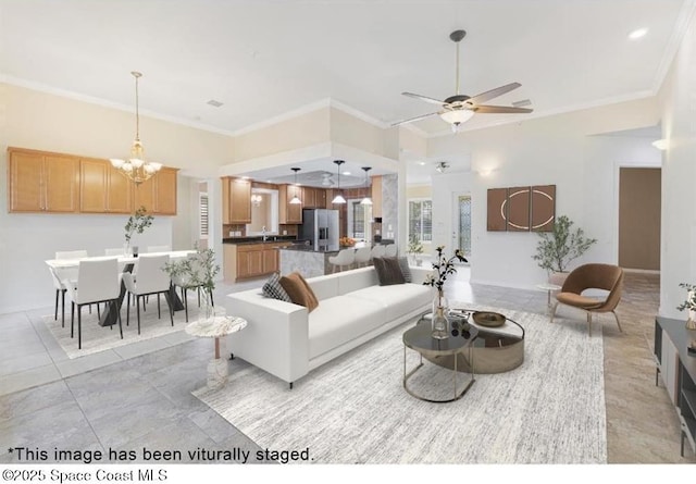 living room featuring ceiling fan with notable chandelier and ornamental molding