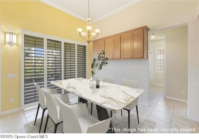 tiled dining area featuring a notable chandelier and crown molding