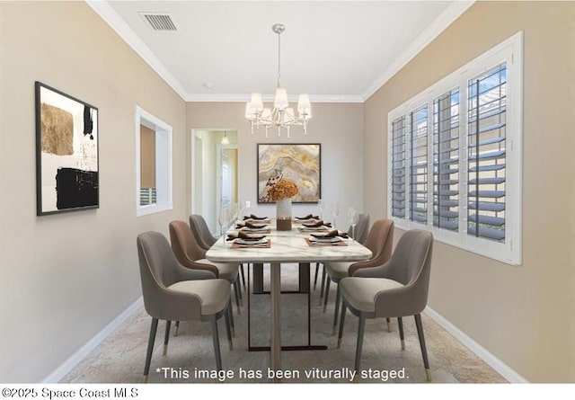 dining space featuring carpet floors, a chandelier, and ornamental molding