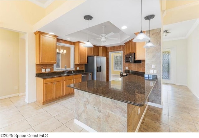 kitchen featuring decorative backsplash, appliances with stainless steel finishes, kitchen peninsula, and a raised ceiling