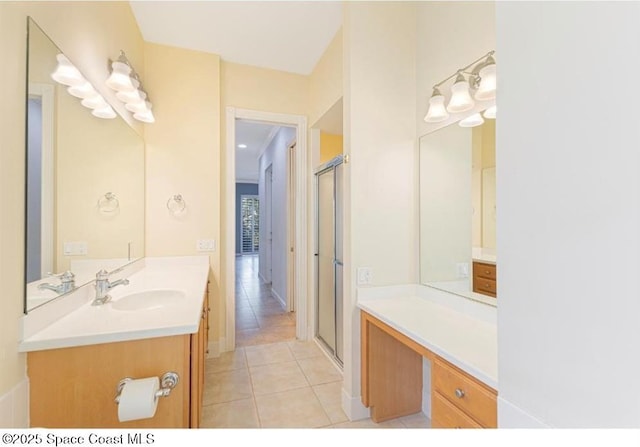 bathroom with tile patterned floors, a shower with door, and vanity