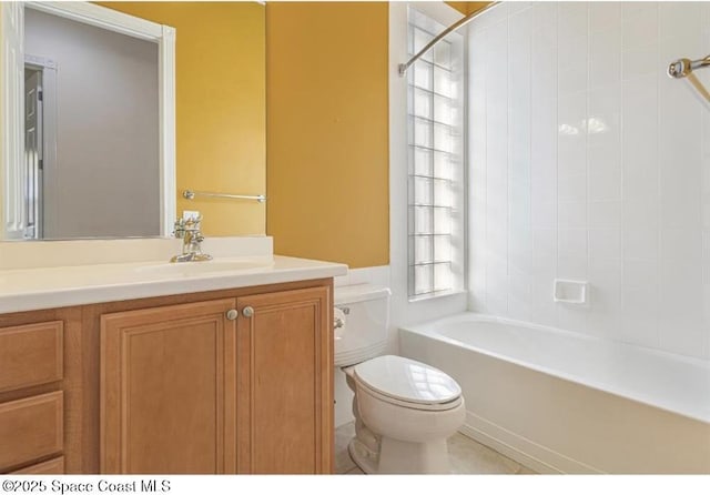 full bathroom with tiled shower / bath, vanity, and toilet