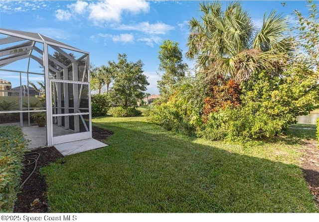 view of yard featuring glass enclosure