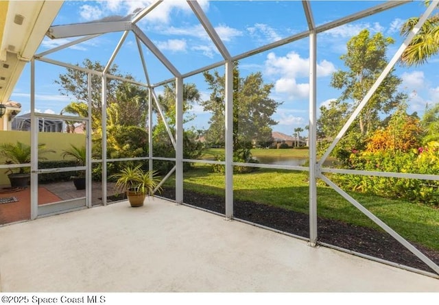 unfurnished sunroom featuring a water view