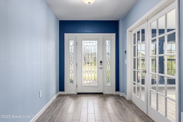 doorway with a healthy amount of sunlight and hardwood / wood-style floors