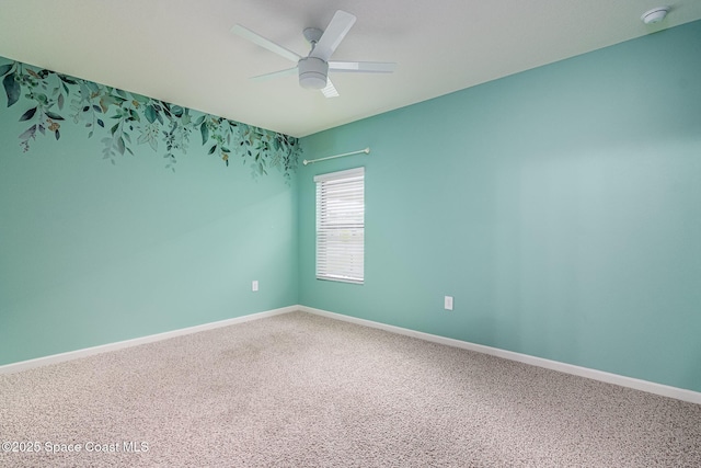 empty room featuring carpet flooring and ceiling fan