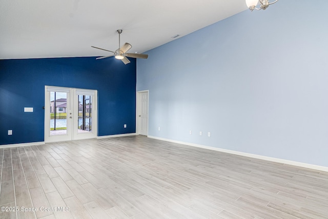 unfurnished living room with french doors, ceiling fan, high vaulted ceiling, and light hardwood / wood-style floors