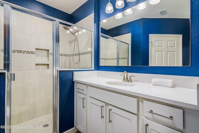 bathroom featuring vanity and a shower with shower door