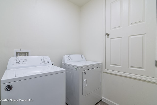 clothes washing area featuring washing machine and clothes dryer