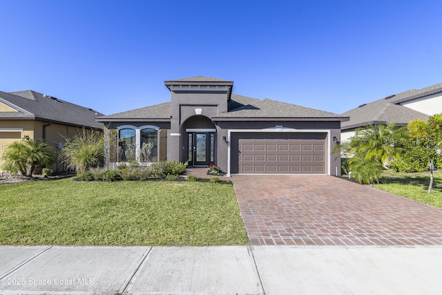 view of front facade featuring a garage and a front lawn