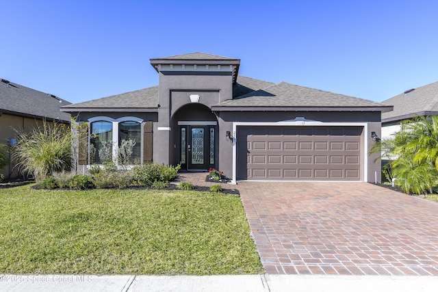 view of front of home with a garage and a front yard