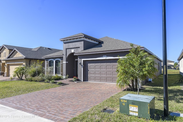 view of front facade with a garage and a front lawn