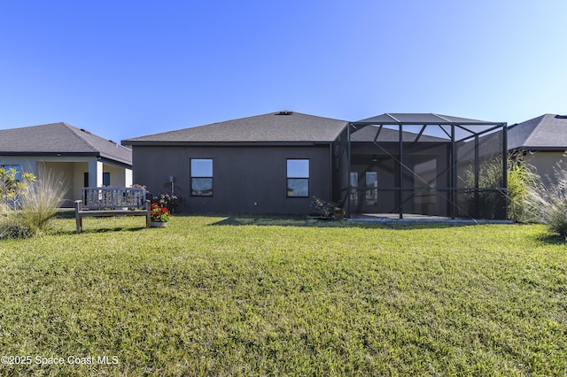 back of house featuring a lawn