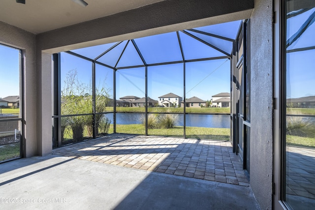 unfurnished sunroom featuring a water view