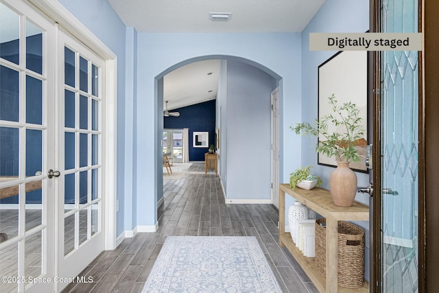 hallway featuring lofted ceiling and french doors