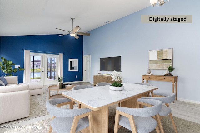 dining area featuring french doors, ceiling fan, high vaulted ceiling, and light wood-type flooring