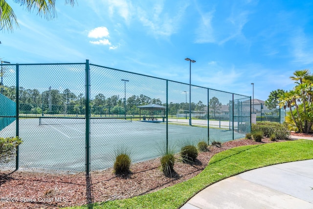 view of tennis court with a gazebo