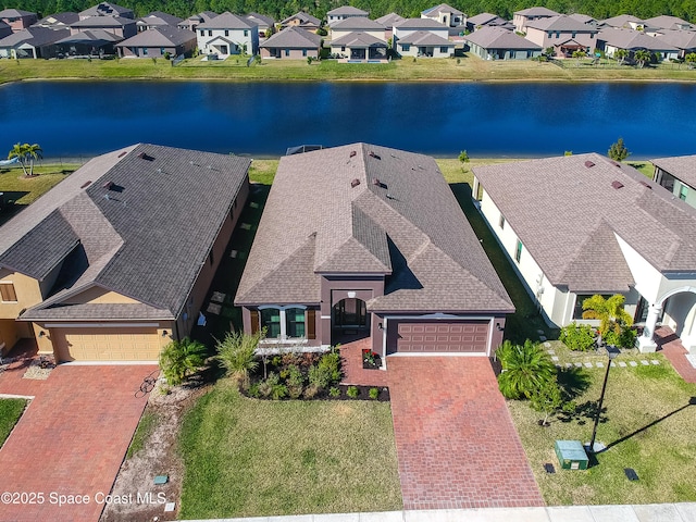 birds eye view of property with a water view