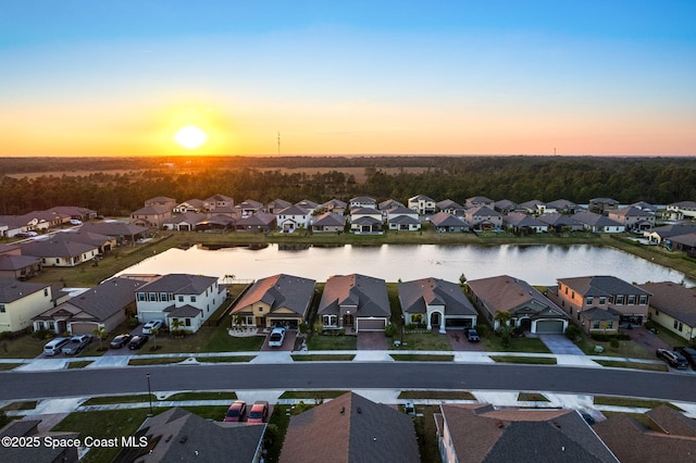 aerial view at dusk with a water view