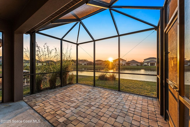 unfurnished sunroom with a water view