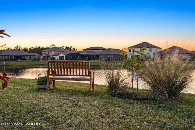 yard at dusk with a water view