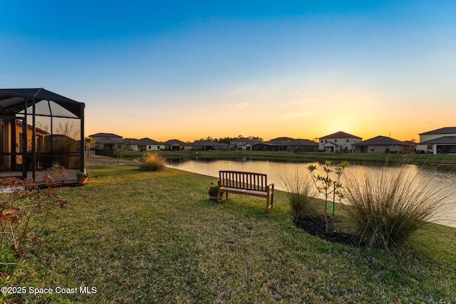 yard at dusk with a water view