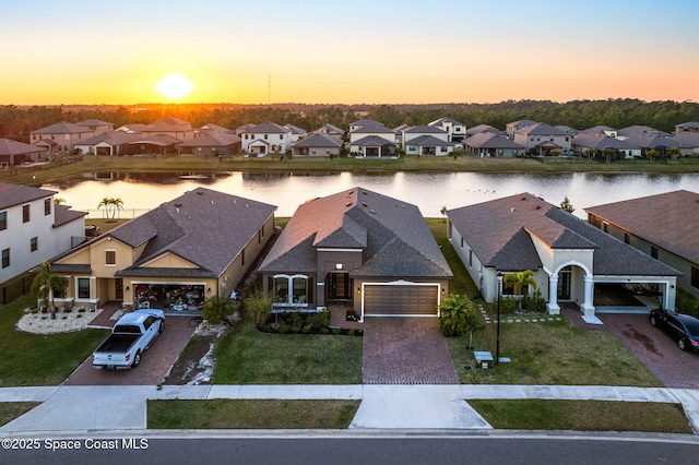 aerial view at dusk with a water view