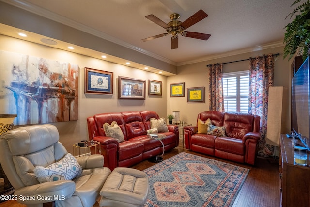 living room with ceiling fan, crown molding, and dark wood-type flooring