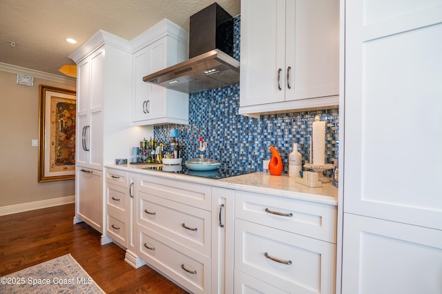 kitchen with wall chimney exhaust hood, dark hardwood / wood-style flooring, decorative backsplash, black electric stovetop, and white cabinets