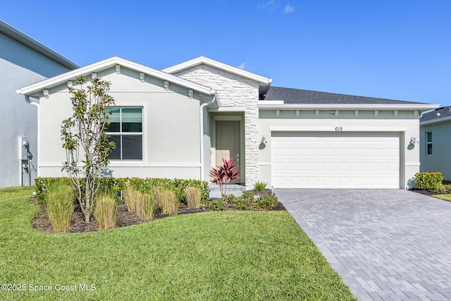 view of front of home with a front lawn and a garage