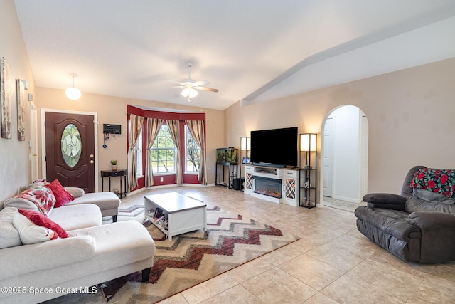 tiled living room with vaulted ceiling and ceiling fan