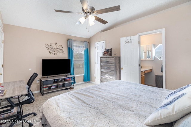 bedroom with ceiling fan, ensuite bathroom, light colored carpet, a textured ceiling, and vaulted ceiling