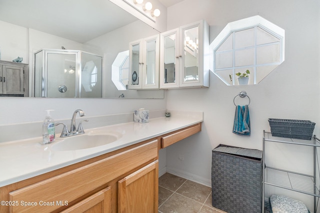 bathroom with tile patterned flooring, vanity, and a shower with door