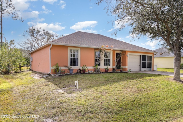 ranch-style house featuring a front lawn and a garage