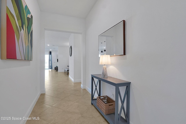 hall with light tile patterned floors